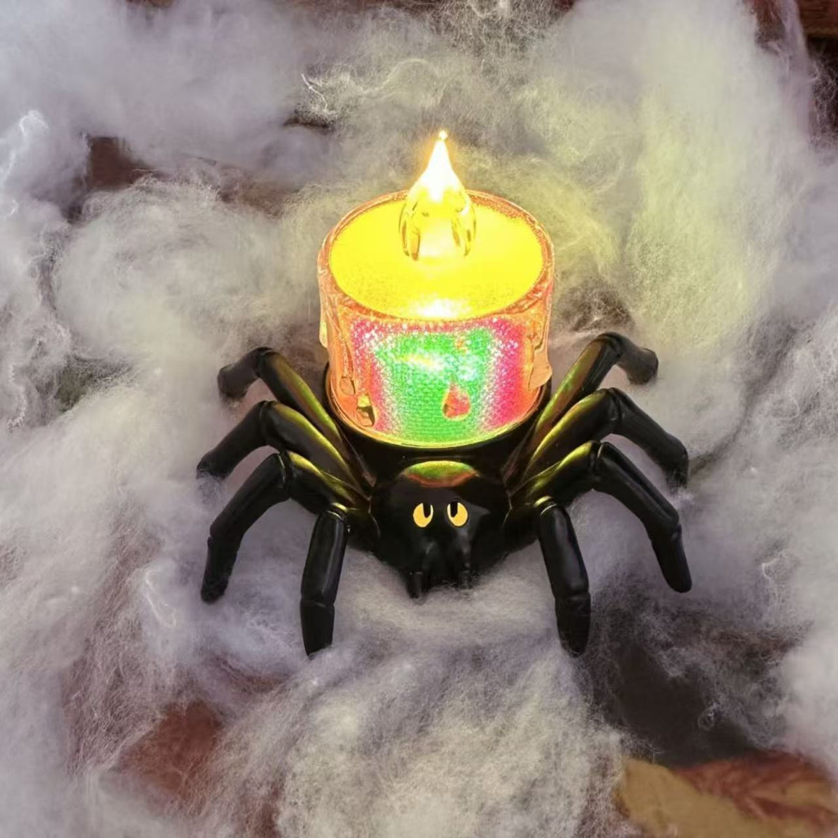 a toy spider with a lit candle on its back