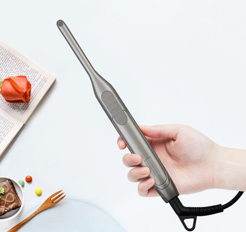a hand holding a hair straightener