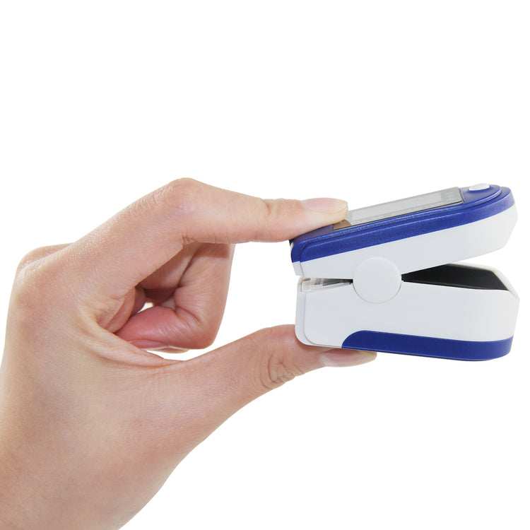 a hand holding a pulse oximeter