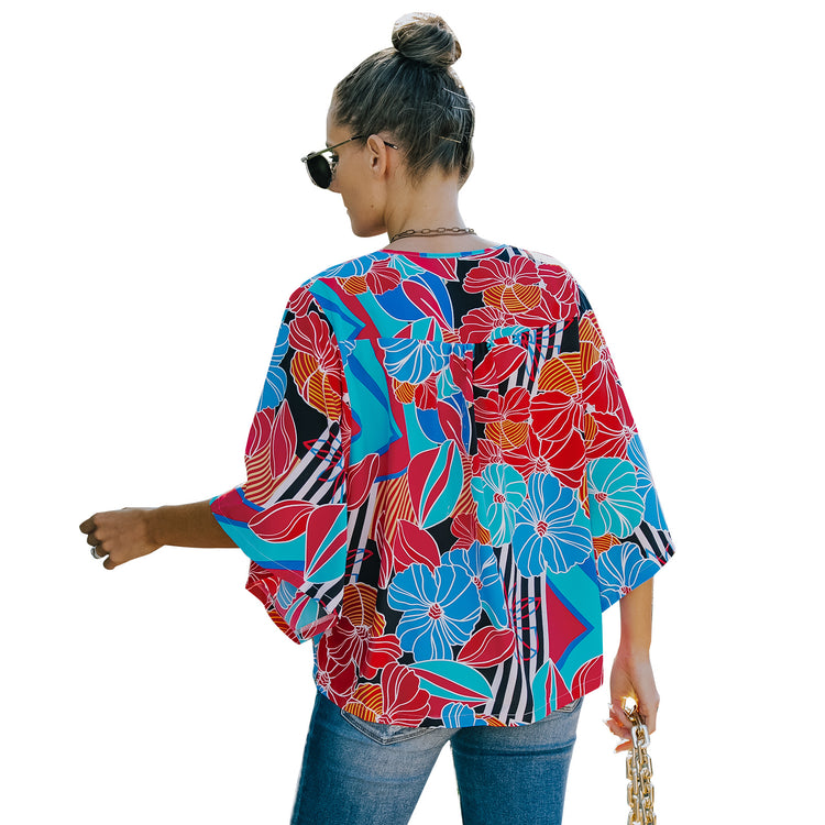 a woman wearing sunglasses and a colorful shirt