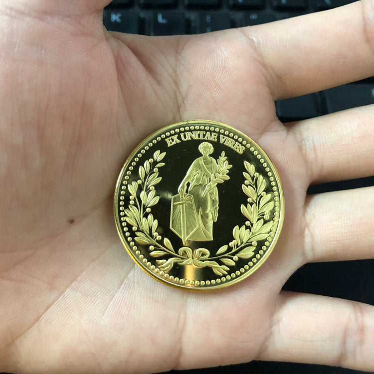 a hand holding a gold coin