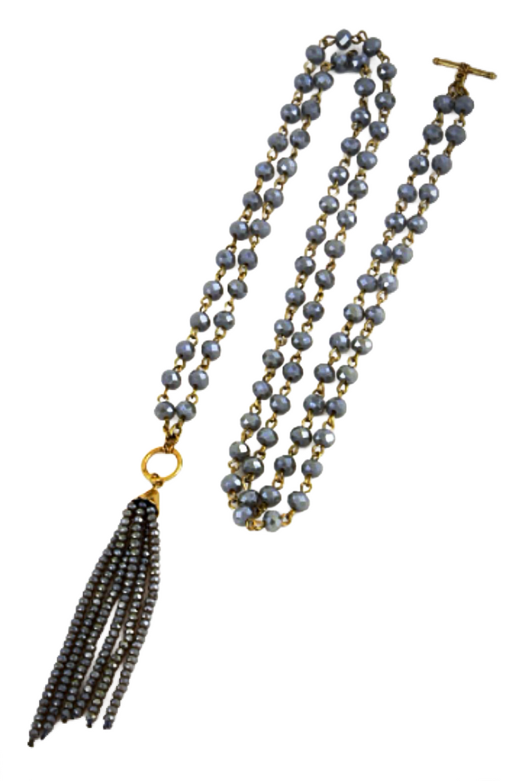 a long necklace with a tassel