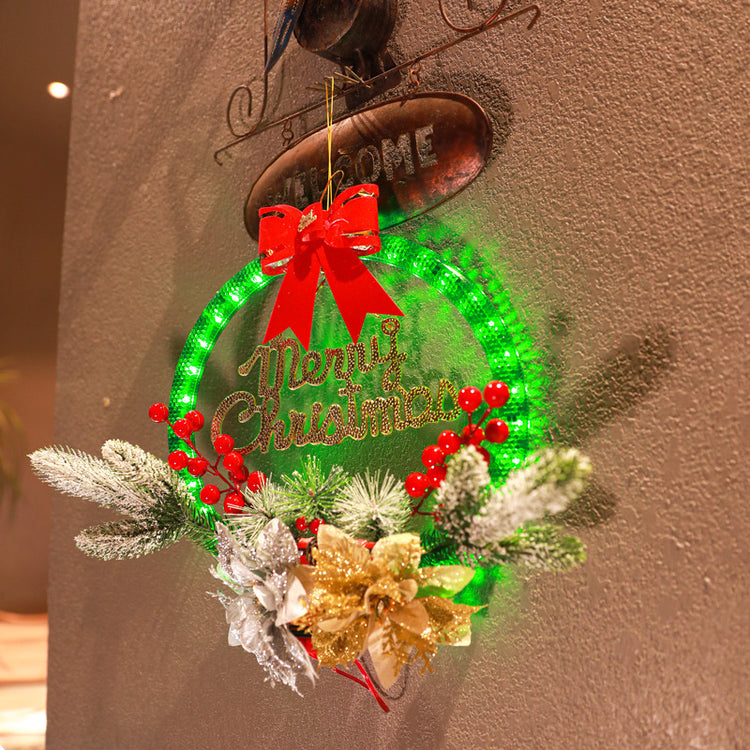 a christmas wreath with lights and flowers