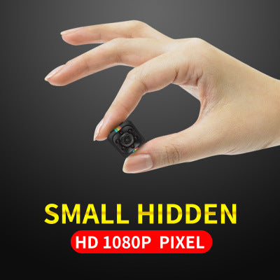 a hand holding a small black cube
