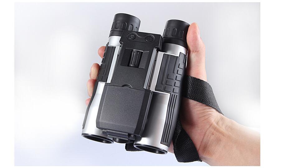 a hand holding a pair of binoculars