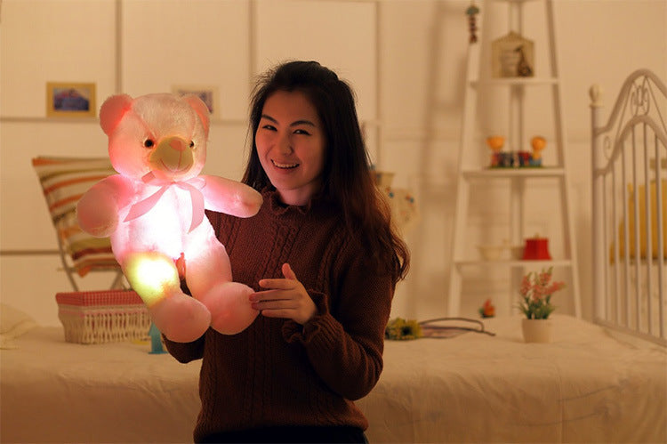 a woman holding a stuffed animal