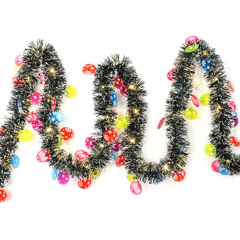 a black tinsel with colorful lights and candy