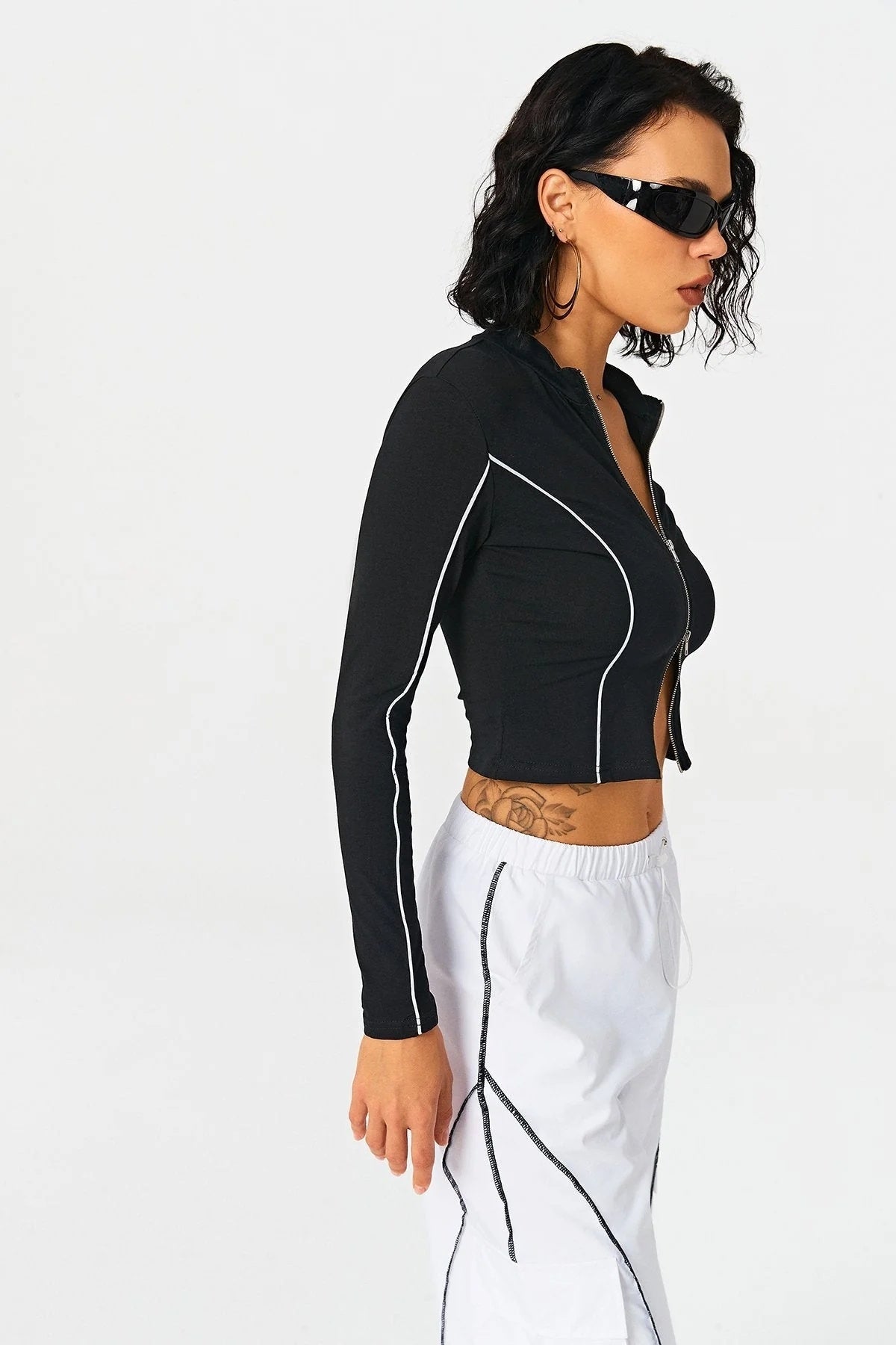 a woman in a black shirt and white shorts