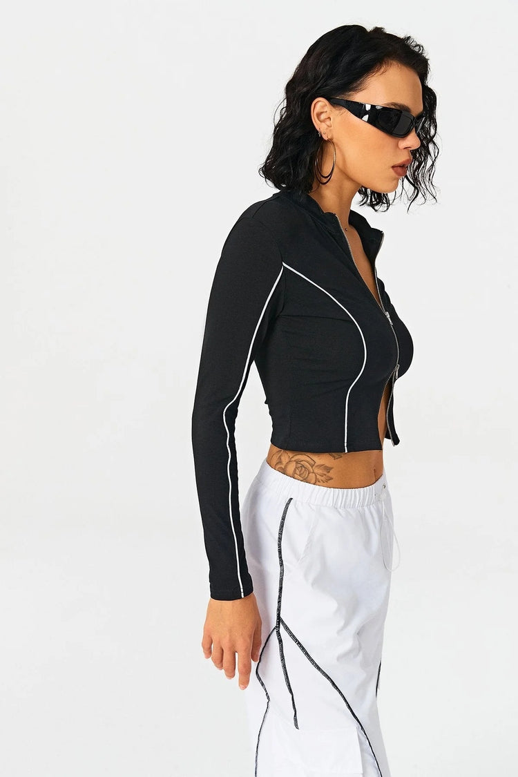a woman in a black shirt and white shorts