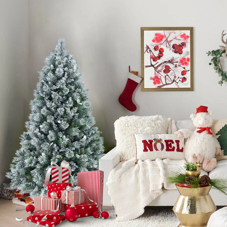 a christmas tree with presents and a couch