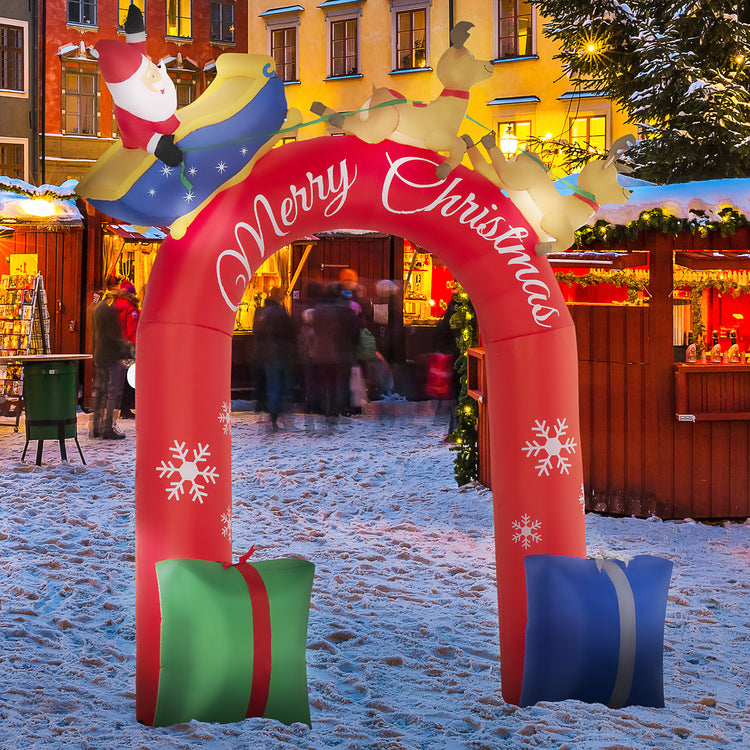 a red inflatable archway with presents in the snow