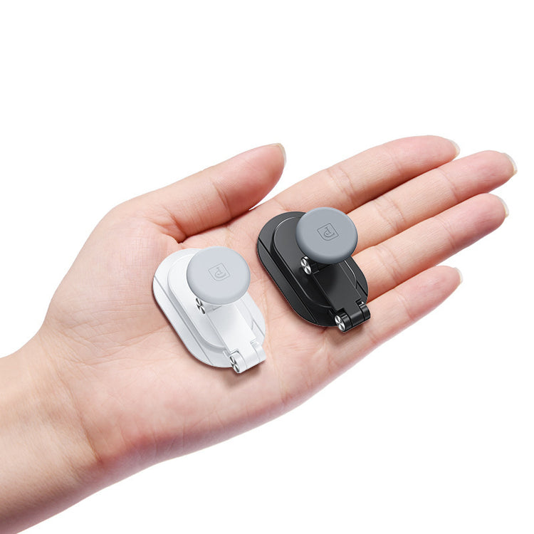 a hand holding a pair of small objects