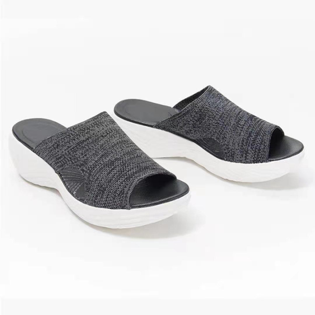 a pair of black and white slippers