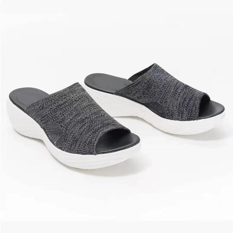 a pair of black and white slippers