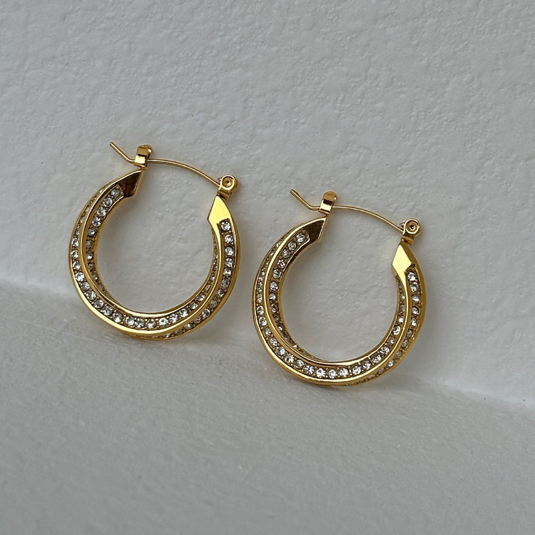 a pair of gold hoop earrings