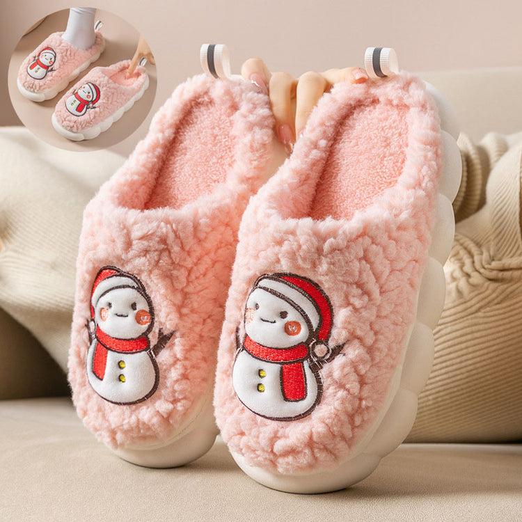 a pair of pink slippers with snowman images