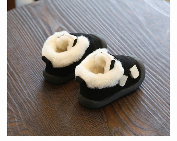 a pair of black and white baby shoes