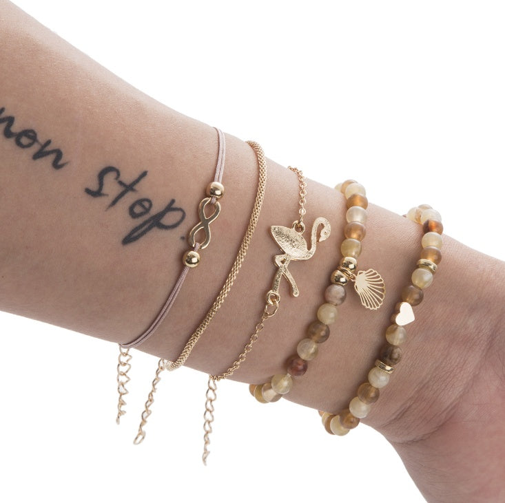 a wrist with many bracelets