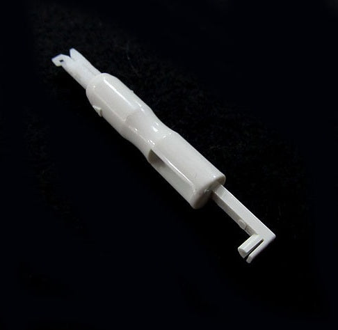a white plastic object on a black surface