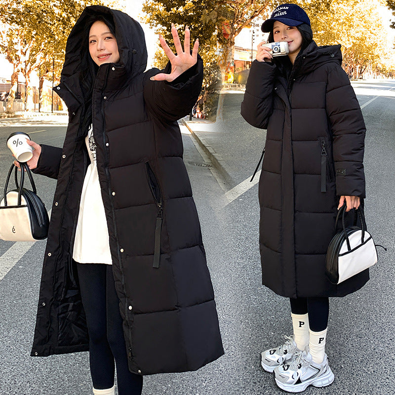 a woman in a long black coat
