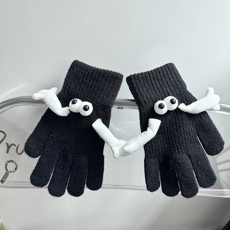 a pair of black gloves with eyes and mouth