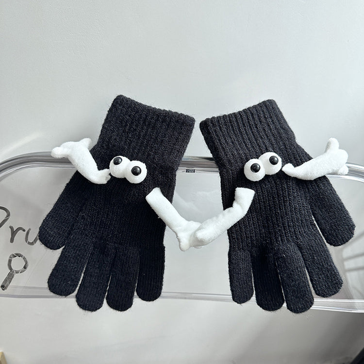 a pair of black gloves with eyes and mouth