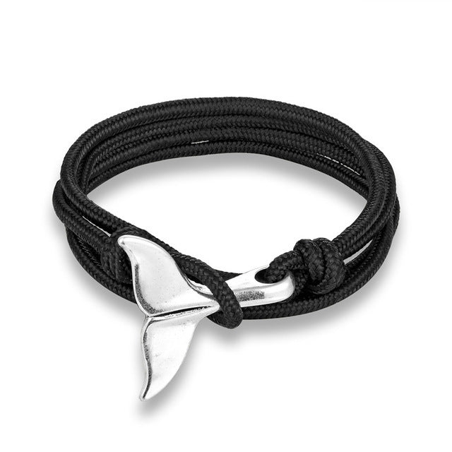 a black rope bracelet with a silver whale tail