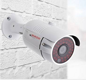 a white camera on a brick wall