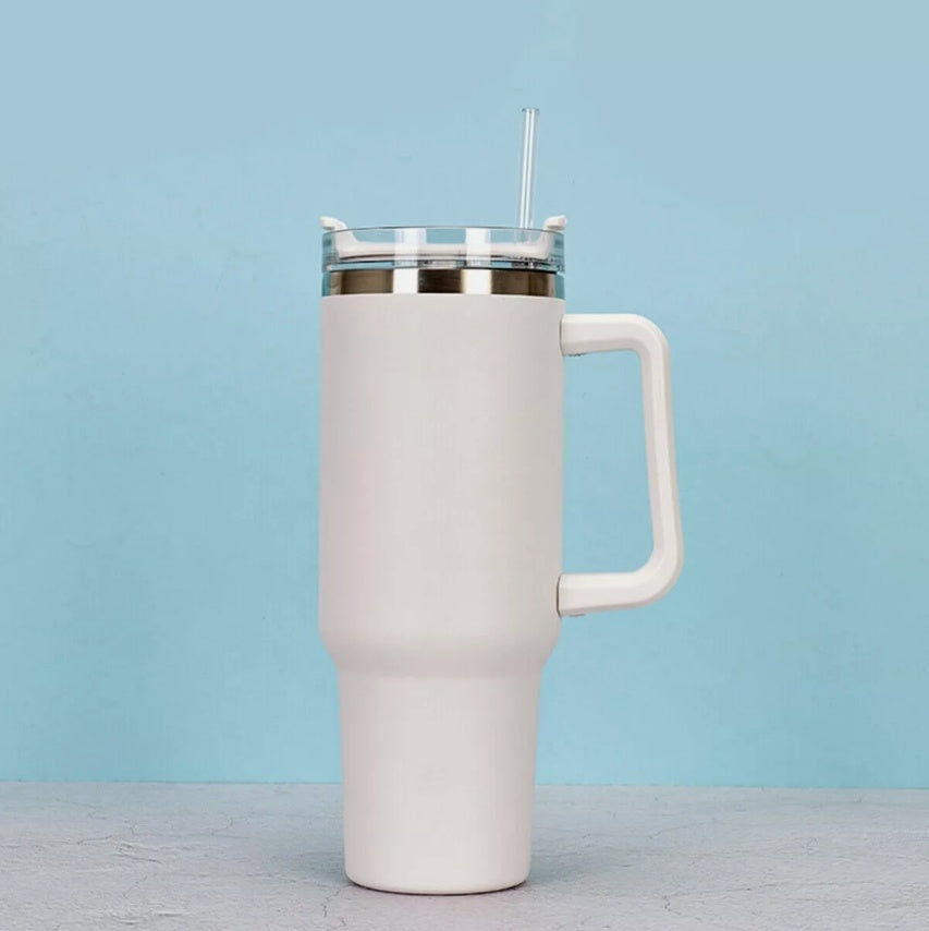a white mug with a straw