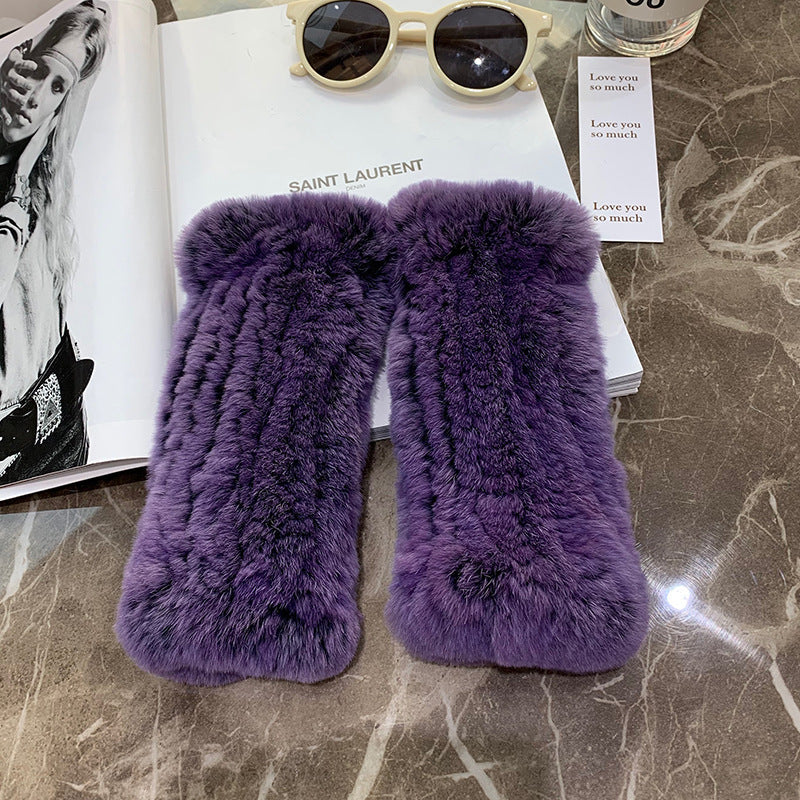 a purple fur gloves on a table