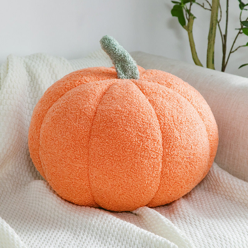 a pumpkin on a white blanket