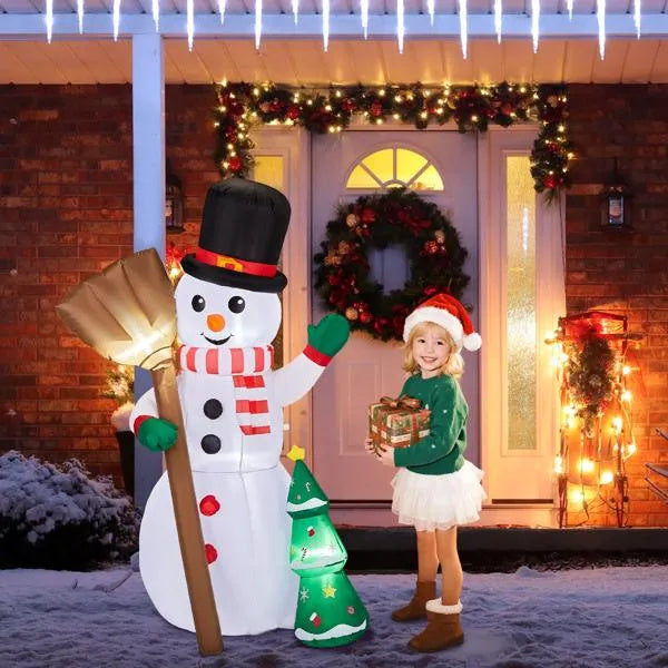 a girl standing next to a snowman