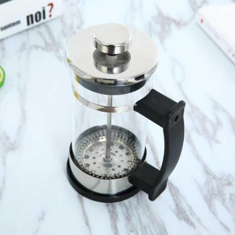 a french press on a marble surface