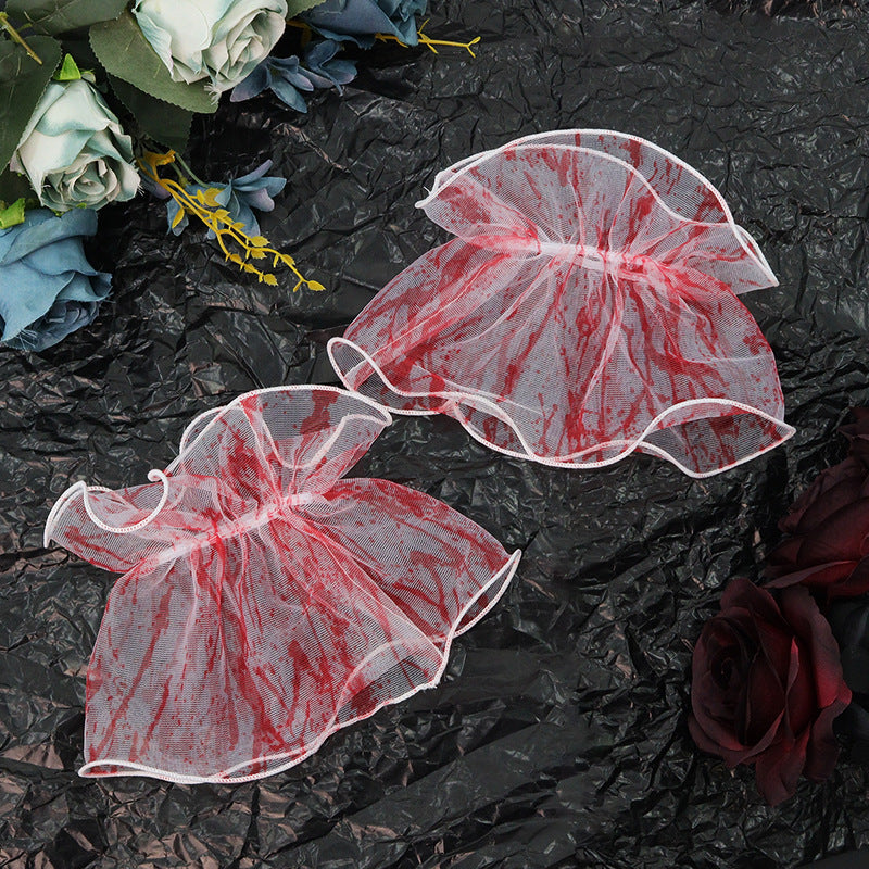 a group of red and white mesh petals on a black surface with roses