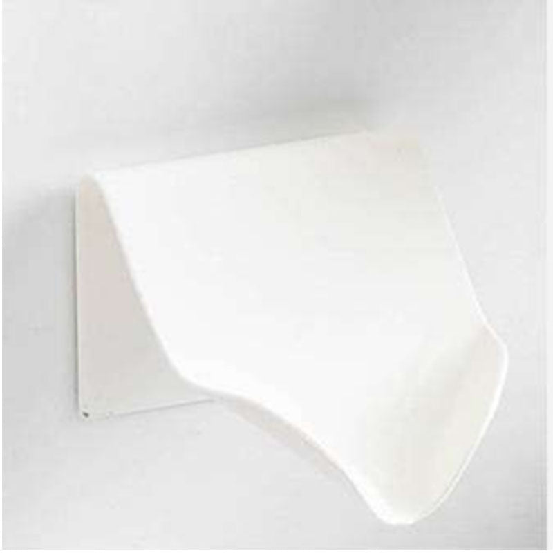 a white plastic object on a white wall