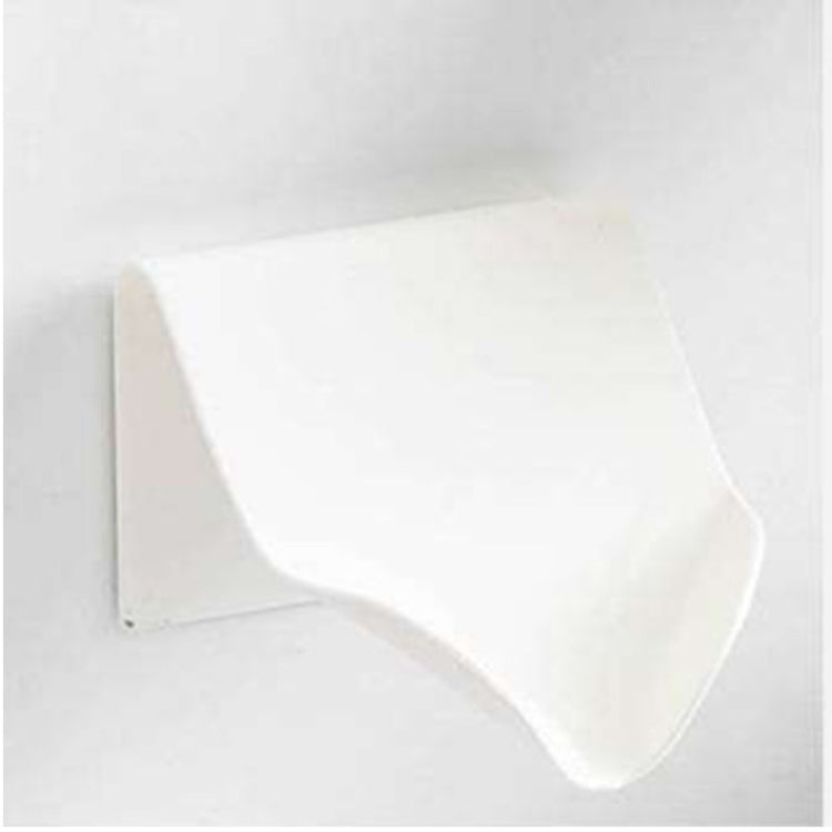 a white plastic object on a white wall