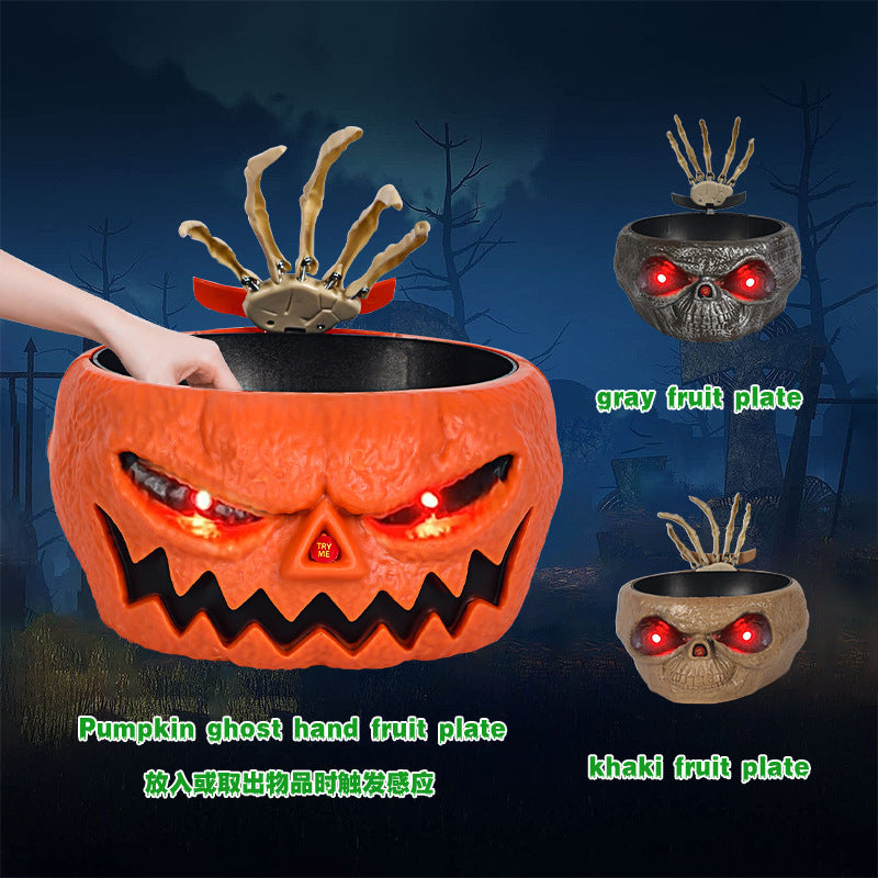 a pumpkin with a hand reaching out to a bowl