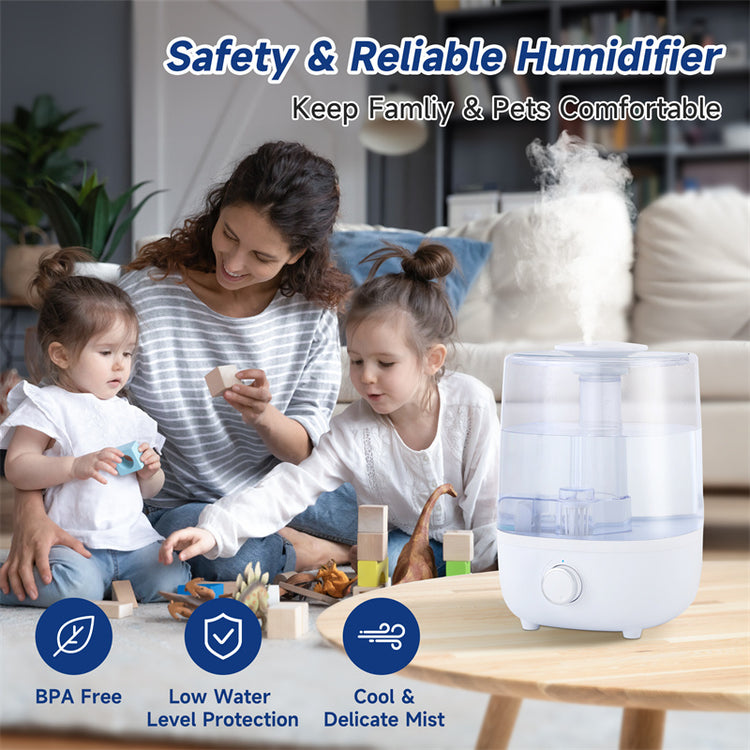 a woman and two children sitting on the floor with a humidifier