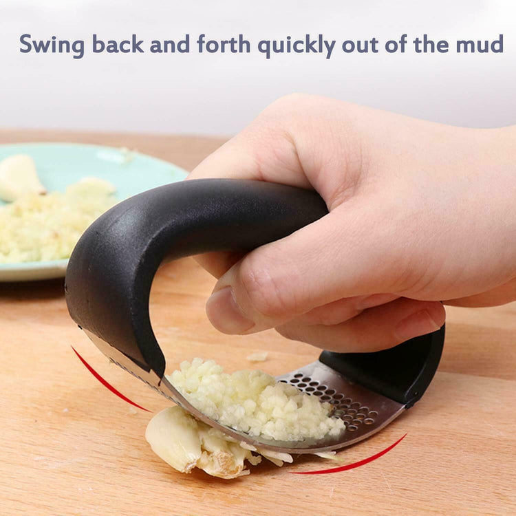 a hand holding a garlic press