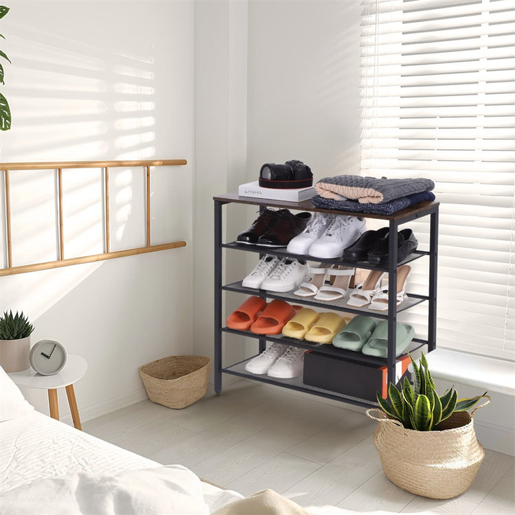 a shoe rack with shoes and blankets in a room
