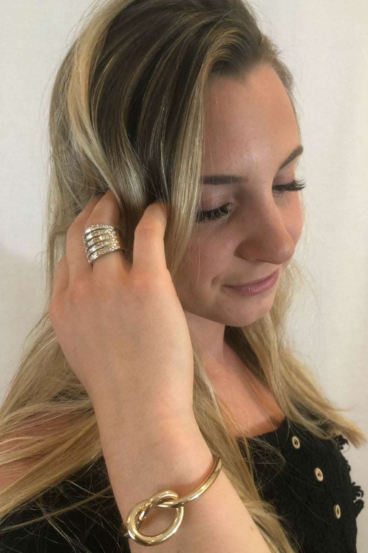a woman with long blonde hair wearing a ring