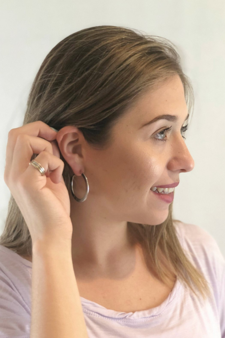 a woman with her hand on her ear