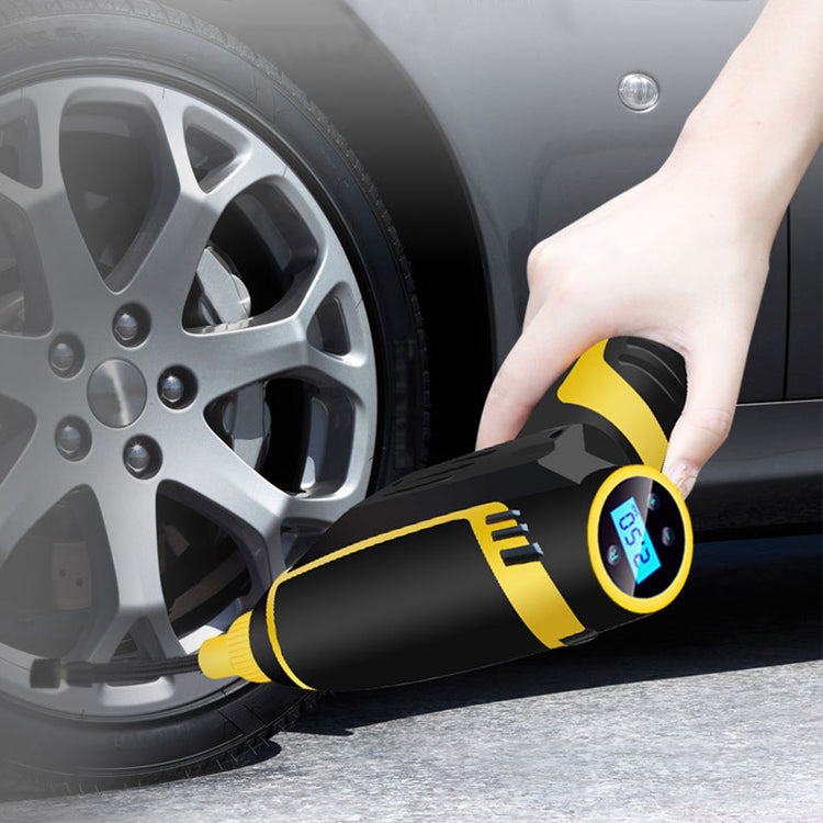 a hand holding a yellow and black device