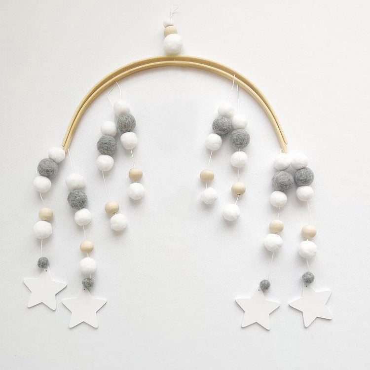 a white and grey ball and star from a gold hoop