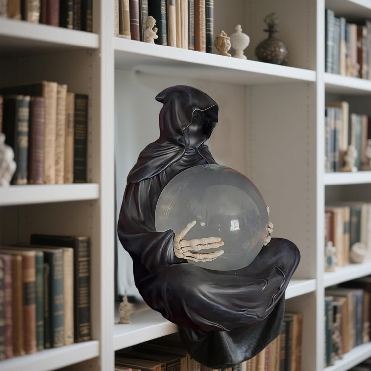 a statue of a person holding a crystal ball on a shelf of books