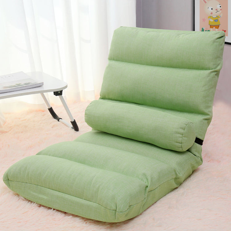 a green chair on a pink carpet