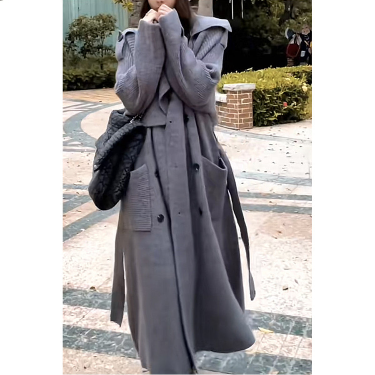 a woman in a long coat