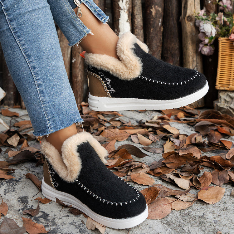 a person wearing black and white slippers