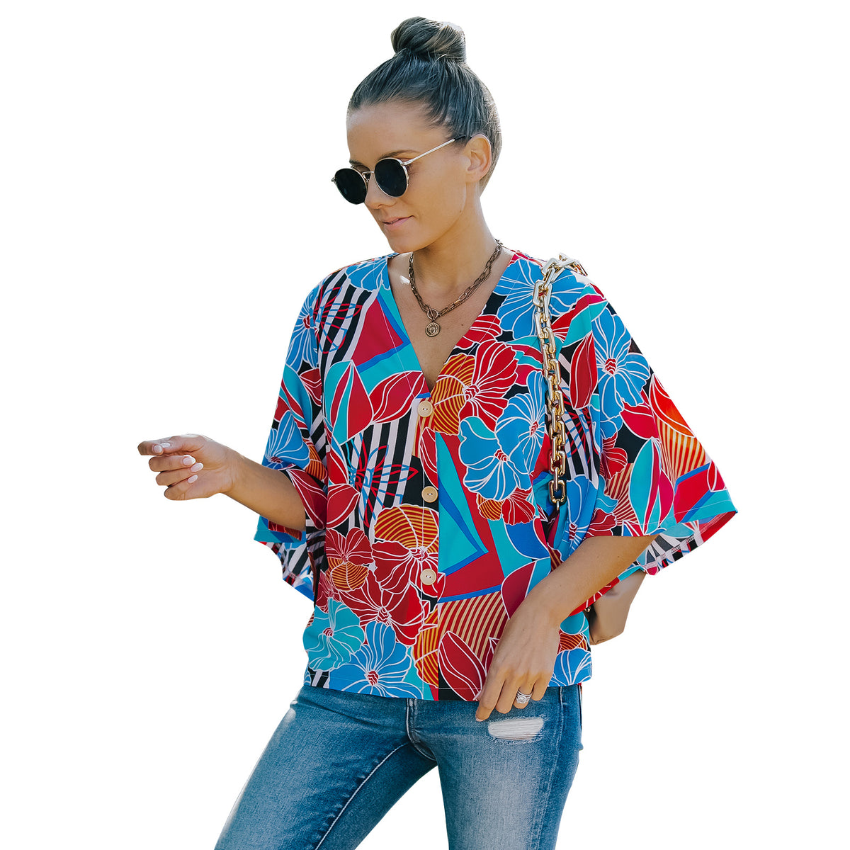 a woman wearing sunglasses and a colorful shirt