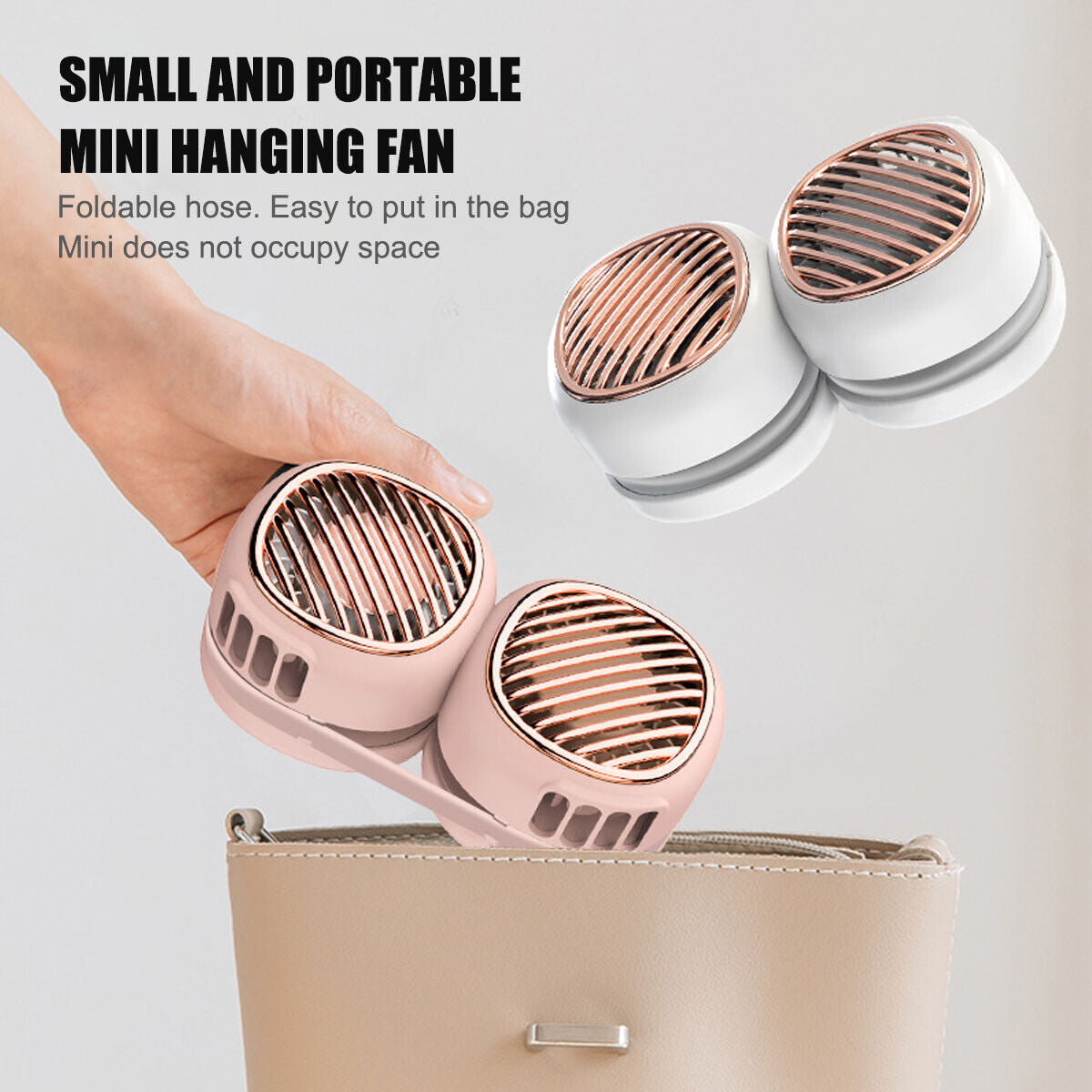 a hand holding a small portable mini fan